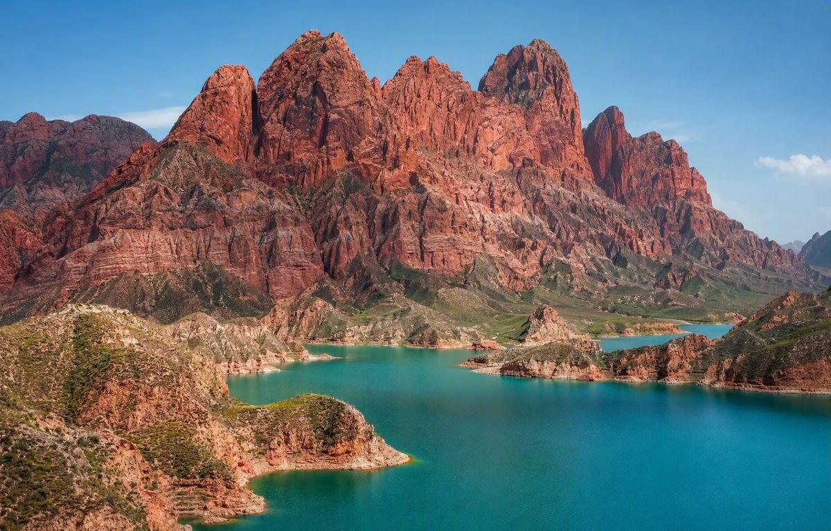 Kanbula's red cliffs above blue water
