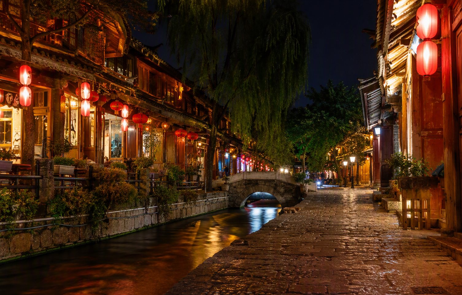 Dali Old Town — red lanterns and canal water along Renmin Road after dark